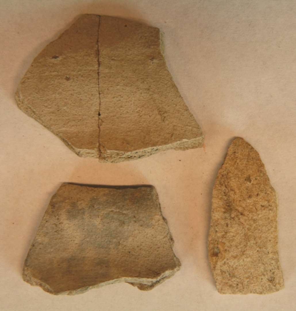 3 sideskår af pibelersgods, muligvis fra kugleformet potte, af porøst gråhvidt og tykvægget gods (Andenne?). C1.