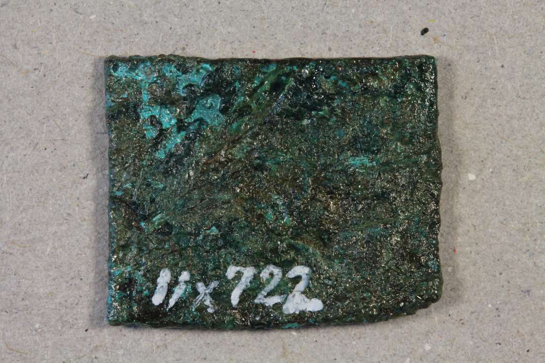 plade. Kons.  Kobber/bronze blikplade 1,6 x 1,3 cm.