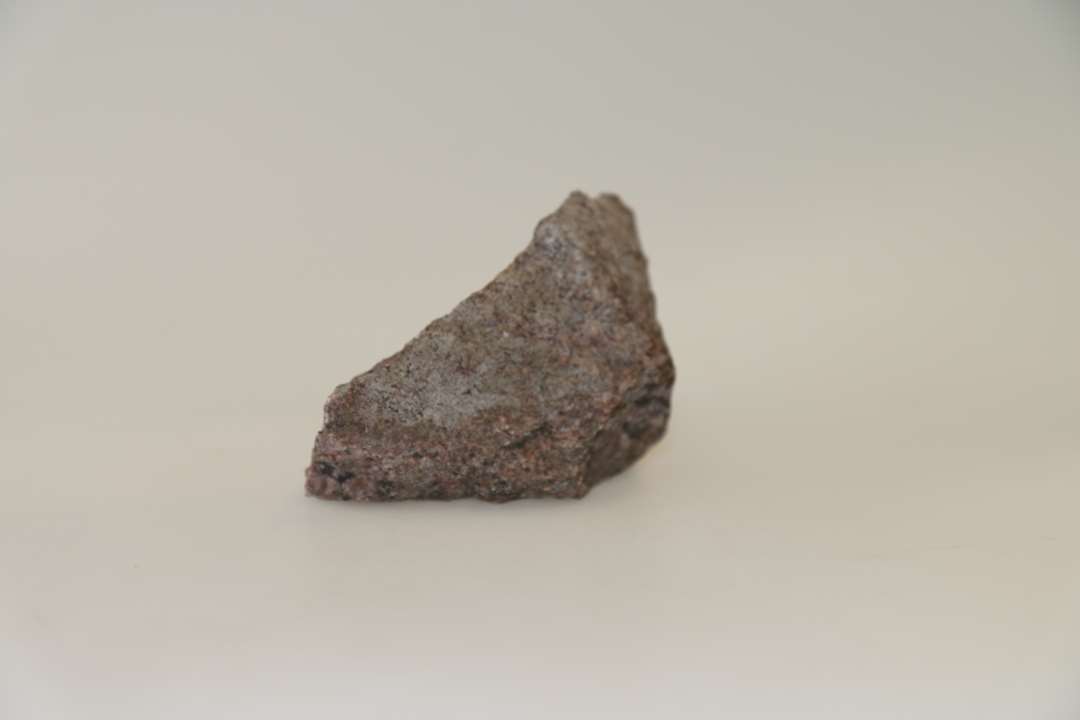 Vindueskvader af granit (afbrækket hjørne), hører sammen med x5382. Mål: 15,5xca 8 cm.