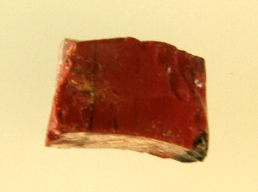 1 mosaikstift af rødbrunlig ugennemsigtig glasmasse.