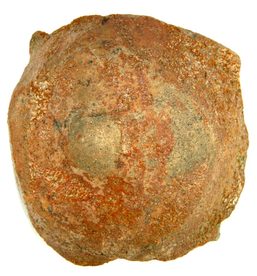Fragment af genstand af glaseret ler. Største mål: 9 cm. Halvkugleformet forhøjning med lettere bekadiget knop på toppen (ligner et bryst). Tykt gods, med hul op i undersiden (til montering?). 