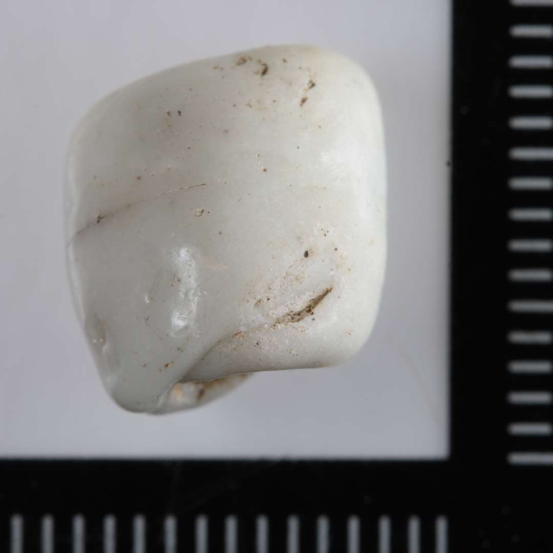 1 fragmenteret, tøndeformet perle af hvid uigennemsigtig glasmasse