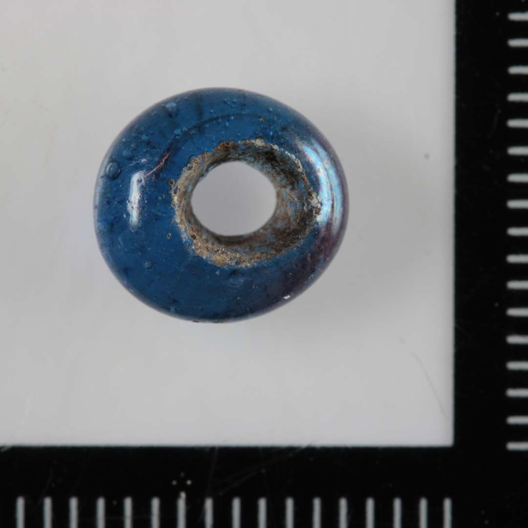 1 ringformet perle af gennemsigtigt, blåt glas.