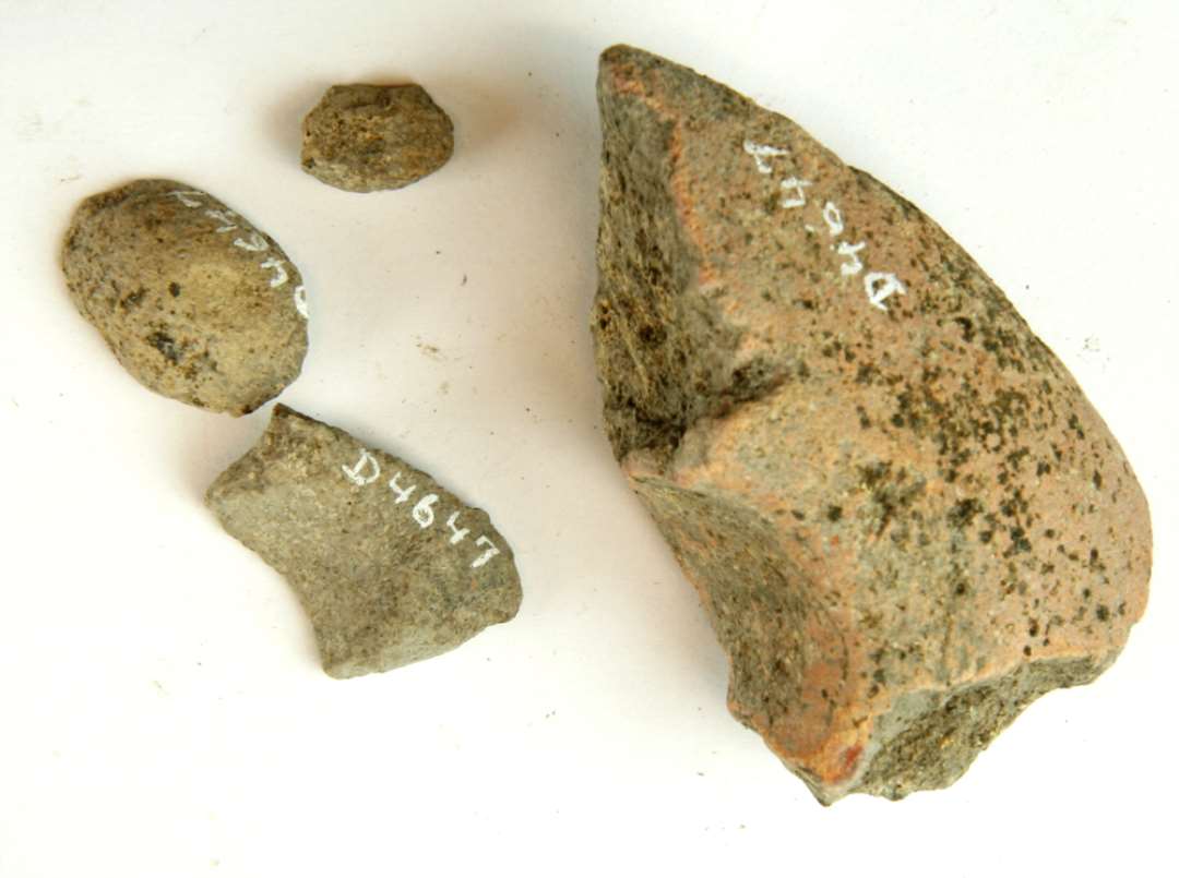 3 fragmenter af discosformede vævevægte af gråbrunlig lermasse. Største mål: 2,5-6,5 cm.