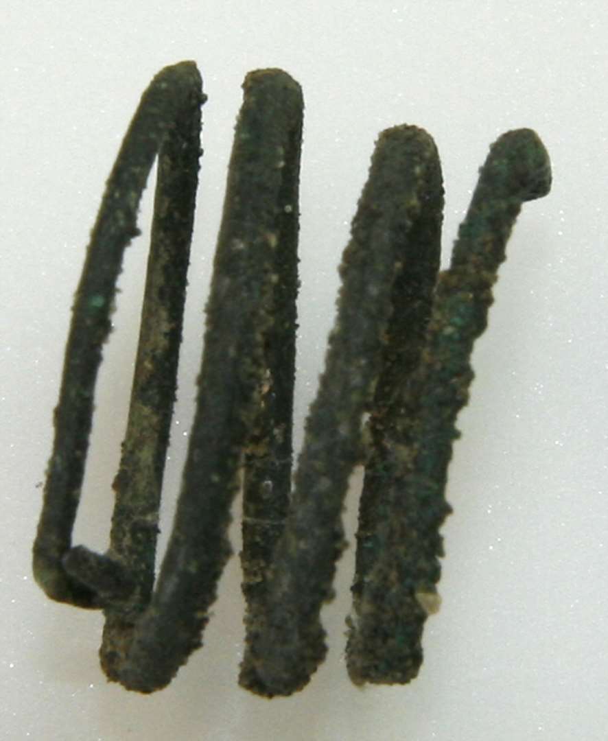 Spiralfingerring af bronze. Af tynd bronzetråd i fire vindinger. Diameter: 1,7 cm.